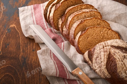 Preview: Fresh homemade rye bread. Traditional spelled sourdough bread cut into slices on a rustic wooden bac