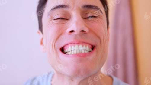 Preview: Man checking his teeth in the bathroom