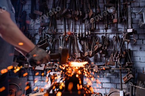 Preview: Authentic handsome indian man in leathern apron hammer industry small business