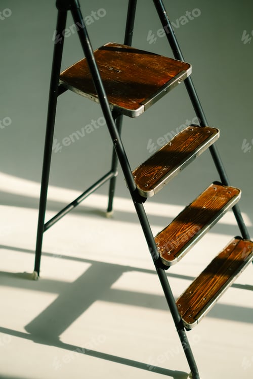 Preview: Ladder in sunlight on a white floor. Metal staircase.