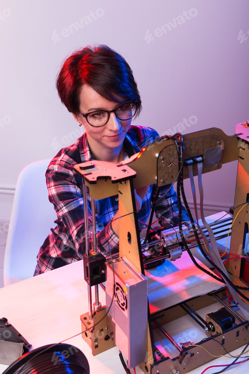 Preview: Technology and engineering concept - Female engineer working in the lab, he is adjusting a 3D