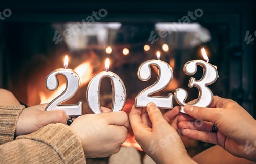 Preview: Candles in the form of numbers 2023 in female hands.