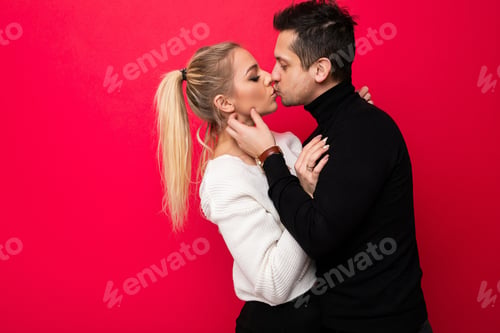 Preview: Photo of a beautiful young blonde woman white knitted sweater and an adult brunet man with stubble