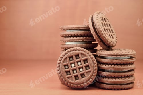 Preview: Chocolate Cookies with Cream Filling on Brown Table