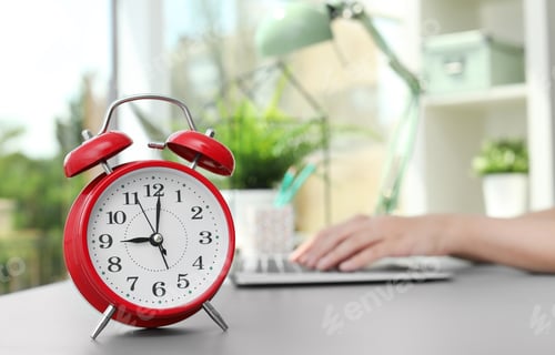 Preview: Red alarm clock on table in office. Time to work