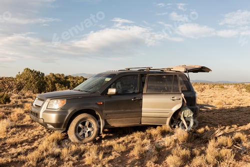 Preview: young boy with SUV, Galisteo Basin, Santa Fe, NM.