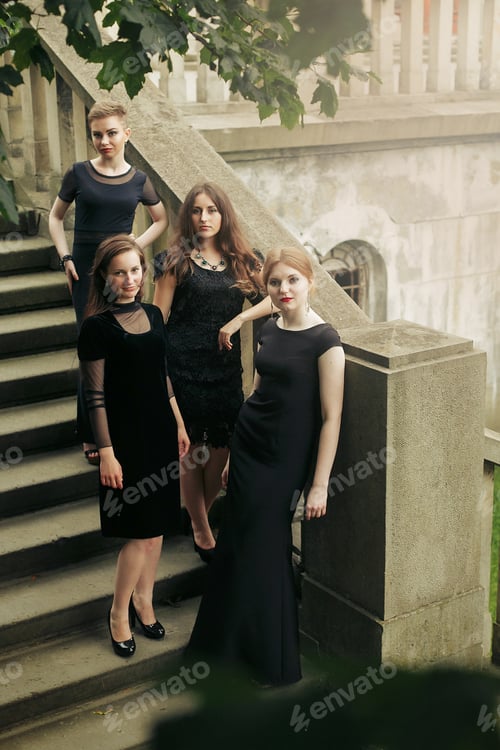 Preview: gorgeous luxury women in black dresses posing smiling on stairs under tree