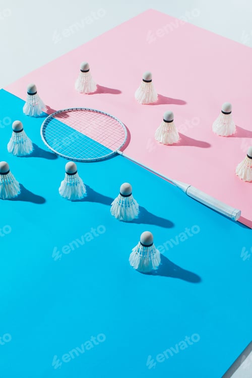 Preview: shuttlecocks around badminton racket on blue and pink papers