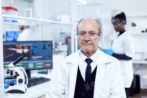 Preview: Senior scientist sitting at his workplace