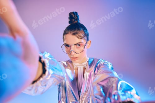 Preview: Vibrant holographic fashion statement by a stylish woman embracing futuristic aesthetics