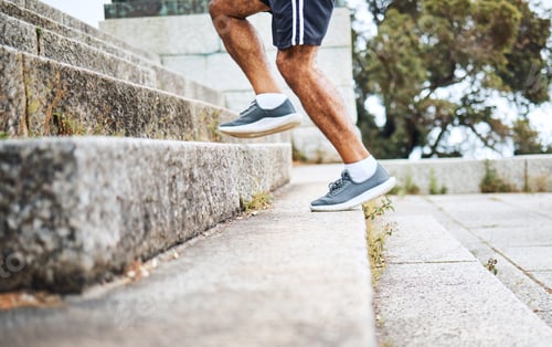 Preview: Man, legs and running on steps in fitness for workout, training or outdoor cardio exercise. Closeup