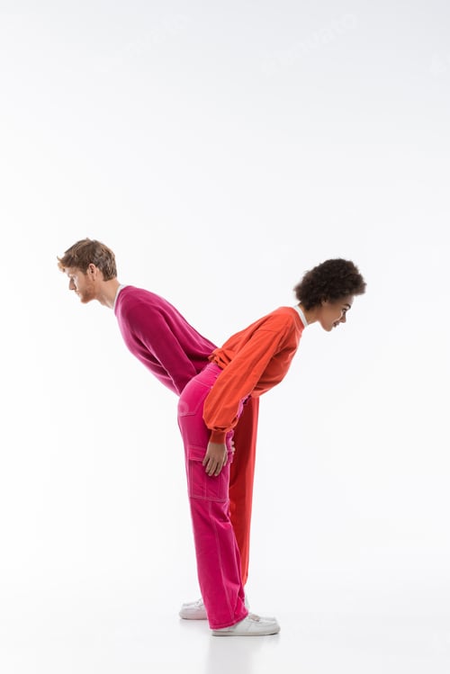 Preview: side view of interracial couple in magenta color clothes showing y letter on white background