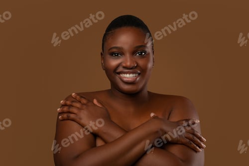 Preview: Beautiful plus size African american woman embracing herself
