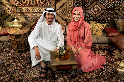 Preview: Young couple from Emirati spending time in a cafe