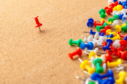 Preview: Group of colorful push pins on cork bulletin board