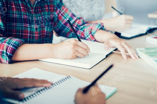 Preview: Student doing homework in library.