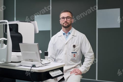 Preview: Portrait of Middle Aged Man Sitting in Clinic Wearing Lab Coat