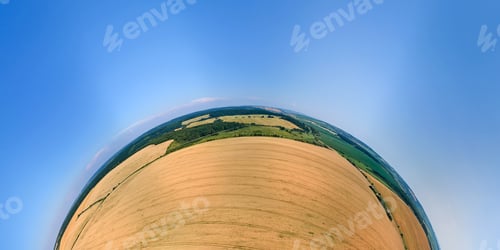 Preview: Aerial view from high altitude of little planet earth with yellow cultivated agricultural field