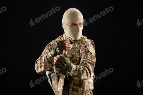 Preview: front view of young soldier in uniform and mask on black background israel tank warriors
