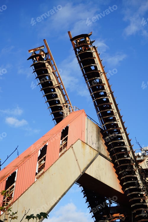 Preview: Vertical shot of an old chain conveyor against a blue sky