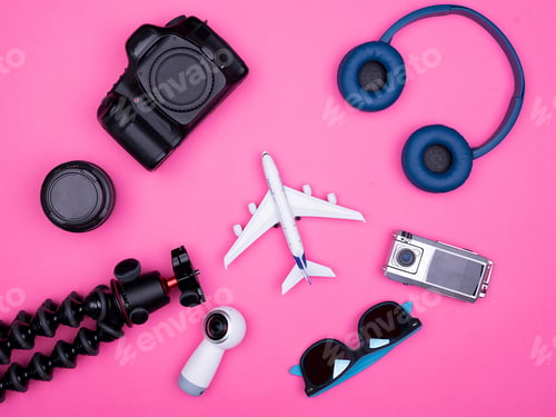 Preview: flat lay top view of traveler photographer accessories on pink background