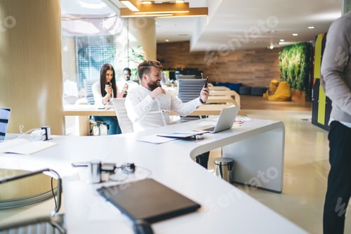 Preview: happy emotional man manager celebrating achievement of completing project