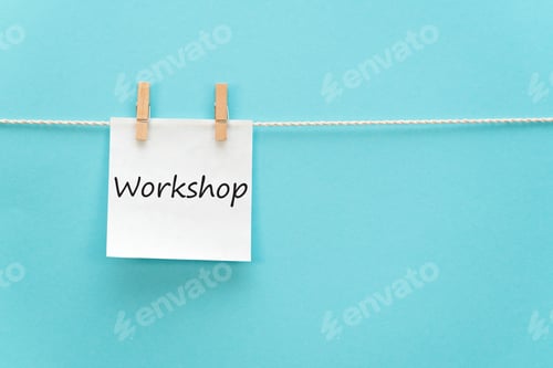 Preview: sticker with the inscription Workshop hangs with a clothespin on a rope on a blue background