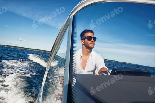 Preview: Young man steering boat, Gavle, Sweden