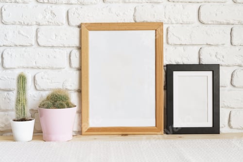 Preview: Square wooden photo frame and cactus plants on the table