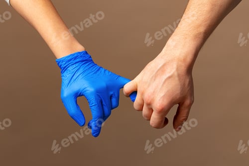Preview: Handshake in a blue gloves, help concept. Personal hygiene during a pandemic