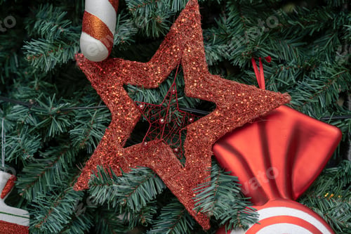 Preview: Decorated Christmas tree in local park, close up of red ornament decoration on the tree
