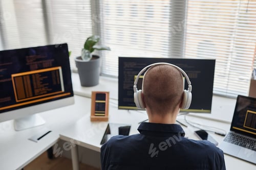 Preview: Young woman as female programmer wearing headphones