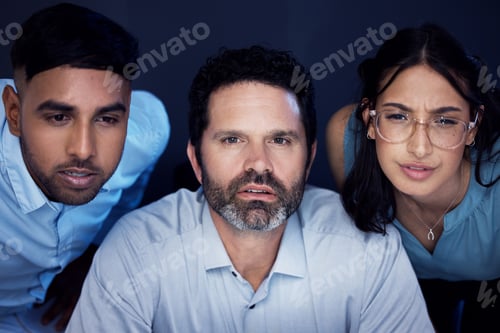 Preview: Shot of a group of businesspeople working on a computer in an office at night