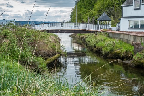 Preview: A Stream Flows Inder A White Walking Bridge At Normandy Park, Washington.