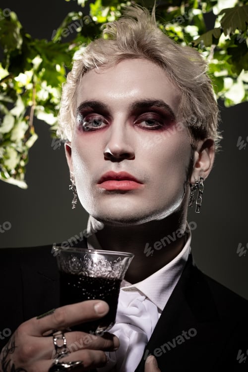 Preview: Young man showcases striking Halloween costume with bold makeup and a mysterious drink
