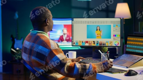 Preview: African american male photo editor multitasking on dual monitors in modern setup