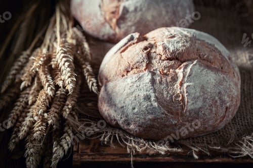 Preview: Fresh loaf of bread on dark and rustic table