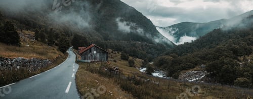 Preview: a wooden cabin by a narrow asphalt road surrounded by mountains covered with trees and grass