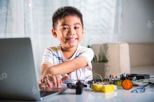 Preview: Asian kid boy learns coding and programming with laptop for Arduino robot car