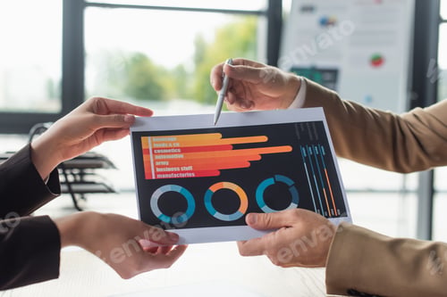 Preview: partial view of businessman pointing at charts in hands of woman, anti-corruption concept
