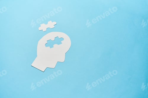 Preview: Concept of memory loss and dementia disease and alzheimer. Head silhouette with jigsaw puzzle