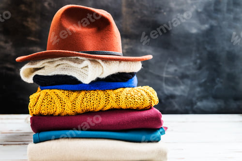 Preview: Stack of colorful warm autumn and winter clothes