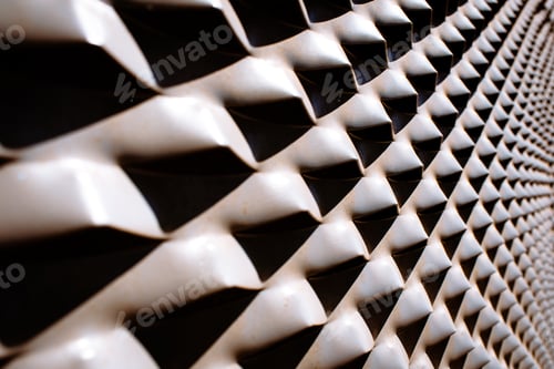 Preview: Industrial background of diagonal metallic protrusions illuminated with strong light