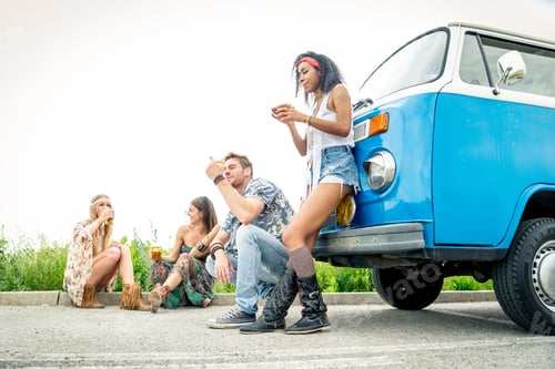 Preview: Happy friends driving a vintage minivan
