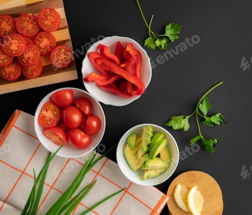 Preview: top view assorted sliced fresh vegetables in white bowls, ingredients for cooking salads