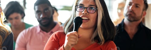 Preview: Woman holding a microphone