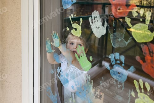 Preview: Kids paint with palms on the window. Quarantine
