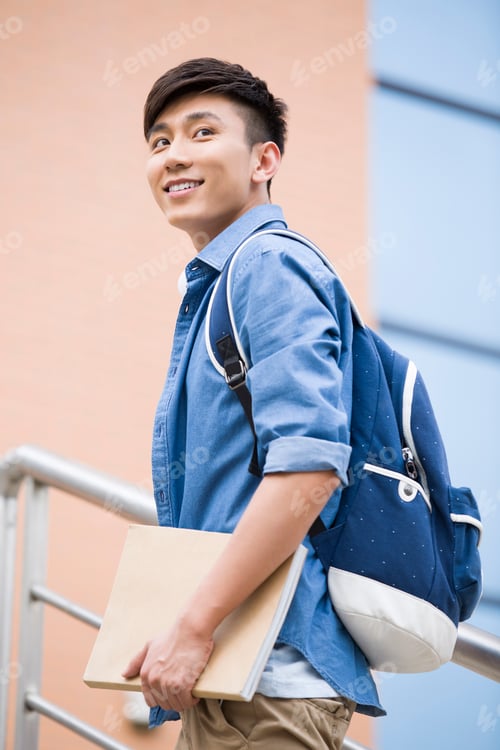 Preview: Male college student outside library