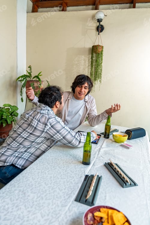 Preview: Friends playing board games, drinking beer and having fun at home