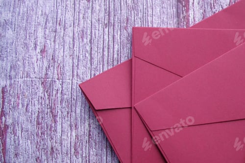 Preview: high angle view of red color envelope wooden background